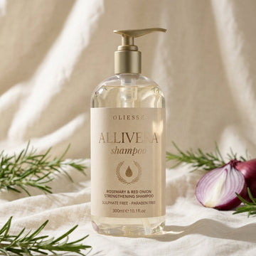 Oliesse Allivera rosemary and red onion shampoo on a shower ledge